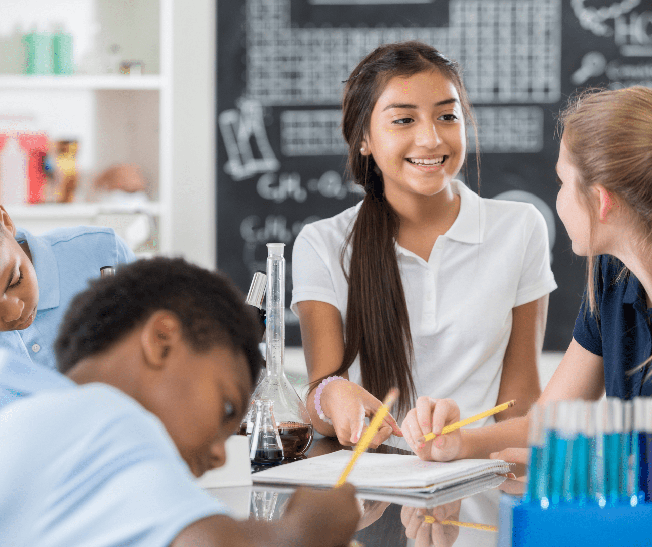 K-12 Students smiling and working in classroom 
